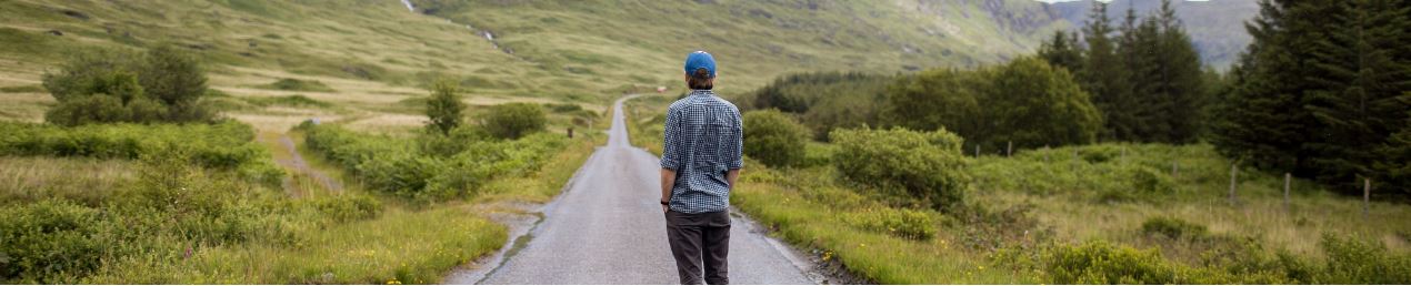 Man looking into distance down road