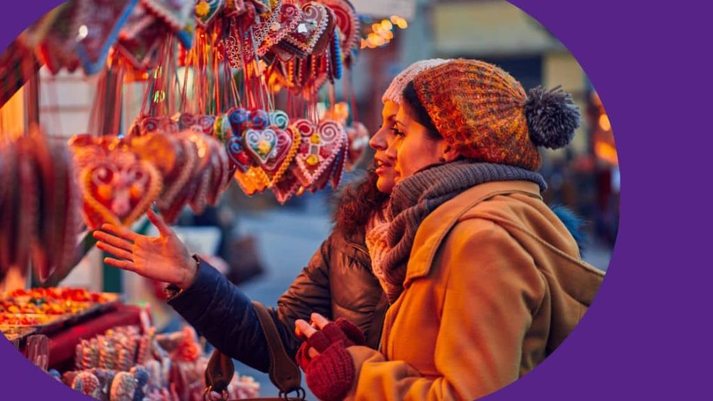 Two travellers exploring a market stall whilst on holiday.
