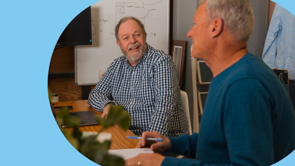 Two travel designers discussing the options for their tour operator software.