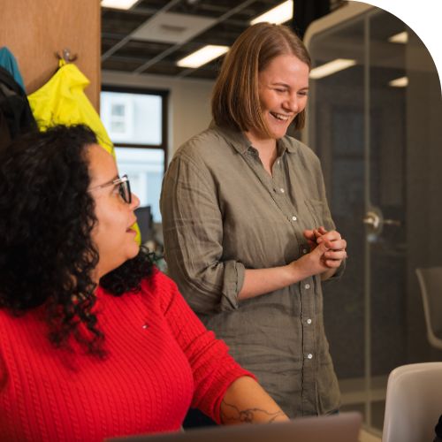 Leave and Benefits at Tourwriter Two professionals smiling